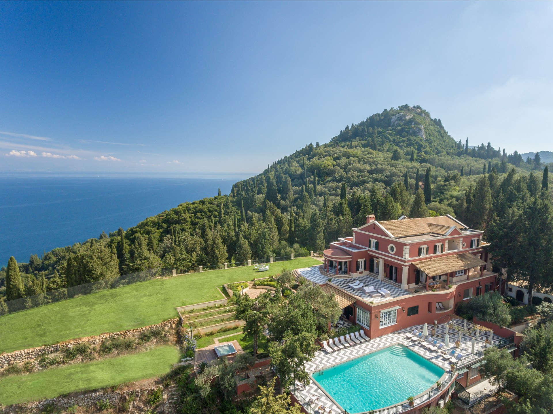 Aerial view of a private villa estate with pool overlooking the Ionian coastline, Corfu