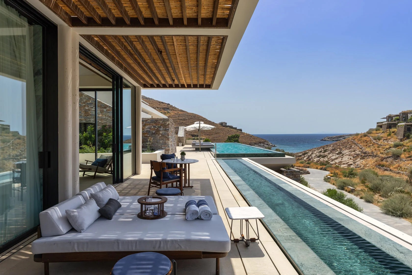 Private villa terrace with infinity pool overlooking the Ionian coastline